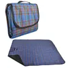 A folded and unfolded picnic blanket with a plaid pattern. Produktbild-Vorschau