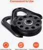 A black pulley system with descriptive icons and text below. Produktbild-Vorschau