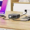 A multi-port charging adapter is shown on a wooden desk, connected to a laptop and two smartphones. Produktbild-Vorschau