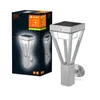 A product shot of a silver LED outdoor wall light with a solar panel on top, placed next to its packaging. Produktbild-Vorschau