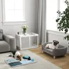Two dogs interacting with a dog puzzle toy on a rug in a living room, with a dog sofa and a dog crate visible. Produktbild-Vorschau