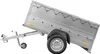 A silver utility trailer is shown against a white background. The trailer bed is tilted upwards. Náhled obrázku produktu