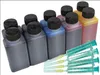 A collection of ink bottles and syringes on a white background. Produktbild-Vorschau