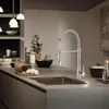 A modern kitchen counter with a sink and faucet, along with some kitchen items. Produktbild-Vorschau