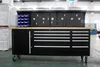 A black rolling workbench with a wooden top and a pegboard back panel, shown in a warehouse or workshop setting. Produktbild-Vorschau