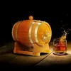 A wooden barrel with a tap, next to a glass of whiskey with a splash. Náhled obrázku produktu