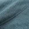 A close-up view of a textured, aquamarine fabric, likely a beanbag or sofa material, showing the weave and a subtle seam. Produktbild-Vorschau