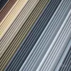 A close-up, diagonal view of multiple stacked, ribbed profiles in various shades of brown, beige, and gray. Anteprima dell’immagine prodotto