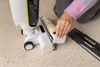 A person is shown using a Kärcher Universalwalze FCV 4 floor cleaner. Produktbild-Vorschau