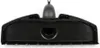 A black vacuum cleaner floor brush attachment shown from the front. Produktbild-Vorschau