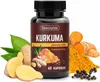 A bottle of Skoczylas Kurkuma supplement surrounded by fresh turmeric roots, ginger, and black peppercorns. Podgląd zdjęcia produktu