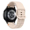 The back of a smartwatch with a beige silicone band. Náhled obrázku produktu
