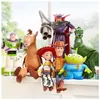 A collection of Toy Story action figures are arranged on a surface, likely a windowsill, with a blurred outdoor background. Náhľad obrázku produktu