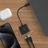A Belkin USB-C adapter is shown connected to a laptop, with a smartphone and wireless earbuds case nearby, on a wooden surface. Produktbild-Vorschau