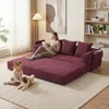 A woman reads a book on a burgundy sofa while a child and a dog play on the floor in front of it. Produktbild-Vorschau