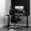 A black ergonomic office chair is positioned in front of a black desk with a computer monitor and accessories. Anteprima dell’immagine prodotto