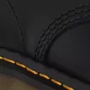 A close-up view of the stitching on a black leather boot. Voir les images du produit