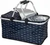 A close-up, studio shot of an open, foldable picnic basket with a silver insulated interior and a navy blue exterior with a white feather pattern. The basket has a silver metal frame and black handles. Náhled obrázku produktu
