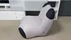 A modern, light gray armchair with black accents is placed on a light gray carpet in a room with white furniture in the background. Produktbild-Vorschau