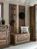 A rustic entryway with a chest, coat racks, and a cabinet. Produktbild-Vorschau