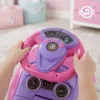 A child's hands are holding a pink and purple toy steering wheel, suggesting a play or driving simulation context. Produktbild-Vorschau