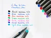 A white lined paper with handwritten text and swatches of different colored fountain pen inks. Produktbild-Vorschau