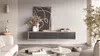 A modern living room with a floating TV stand, artwork, and decorative items. Náhled obrázku produktu