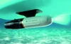 A white Aqua Marina BlueDrive X PRO Power Fin is attached to the underside of a boat, submerged in clear turquoise water. Podgląd zdjęcia produktu