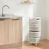 A white rolling cart with four mesh baskets filled with produce, placed in a kitchen next to a sink and cabinets. Anteprima dell’immagine prodotto