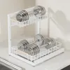A two-tier white metal rack holding two pairs of dumbbells. Voir les images du produit
