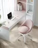 A pink office chair is placed next to a white and pink desk with a laptop and a glass of water on it. Produktbild-Vorschau