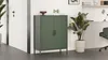 A green cabinet is shown in a room with a plant and a desk. Produktbild-Vorschau