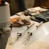 A close-up shot of a Solo Stove Mesa accessory pack, including skewers, marshmallows, and chocolate, set up for s'mores. Produktbild-Vorschau