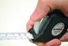 A hand is holding a black Hultafors Talmeter tape measure, with the tape extended. Anteprima dell’immagine prodotto