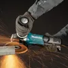 A person wearing work gloves is using a Makita angle grinder to cut a metal bar, creating a shower of sparks. Voir les images du produit