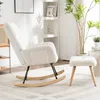 A white fluffy rocking chair and matching ottoman are shown in a well-lit room with a plant and shelving unit in the background. Podgląd zdjęcia produktu