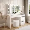 A white vanity table with a lighted mirror and a stool in a well-lit room. Produktbild-Vorschau