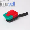 A car cleaning brush with a black handle and red and green bristles, set against a white background. Text and a logo are visible in the upper left corner. Produktbild-Vorschau