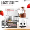 A chocolate fountain with strawberries and text overlays highlighting its features. Podgląd zdjęcia produktu