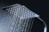 A close-up shot of a modern chrome shower head with water spraying from it. Náhľad obrázku produktu
