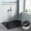 A modern bathroom setting featuring a black, rectangular shower tray with a drain, a wall-mounted shower head, and a close-up inset showing a cutting tool modifying the shower tray. Náhled obrázku produktu