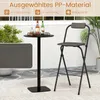 A bar stool and a high table are set up on an outdoor patio with plants and a textured floor. Produktbild-Vorschau