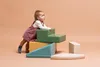 A baby is playing with colorful foam climbing blocks. Anteprima dell’immagine prodotto