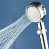 A chrome shower head spraying water, with a blurred tower in the background. Anteprima dell’immagine prodotto
