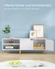 A white TV stand with open shelves and a cabinet, decorated with framed art and a plant. Náhled obrázku produktu