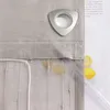 A close-up of a grey linen curtain with a metal grommet and some yellow stains, along with two lemons and a clear plastic tube. Produktbild-Vorschau