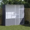 A gray and white aviary is set up on a green lawn in front of a wooden fence and trees. Anteprima dell’immagine prodotto