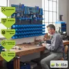 A man is working at a workbench in a workshop, with a tool storage system mounted on the wall behind him. Anteprima dell’immagine prodotto