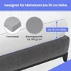 A close-up view of a mattress with a fitted sheet, illustrating its height compatibility and material properties. Produktbild-Vorschau