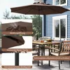 A patio umbrella and outdoor furniture set on a deck next to a blue house. Anteprima dell’immagine prodotto